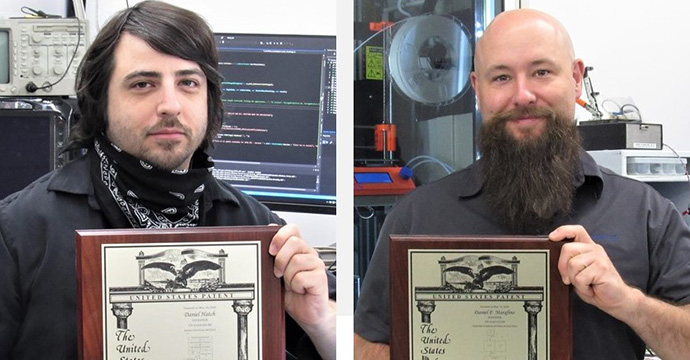 Dan Hatch, Dan Marafino proudly displaying their U.S. Patents