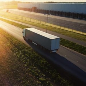 Truck driving into the sun