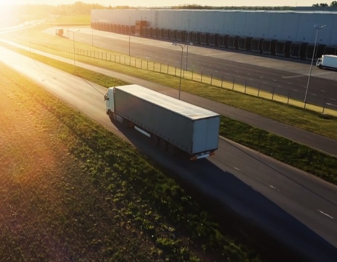 Truck driving into the sun