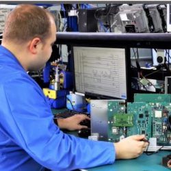 Employee performing service on automotive electronics