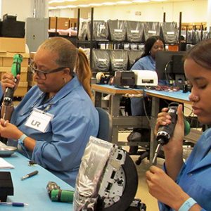 Employees soldering electronics