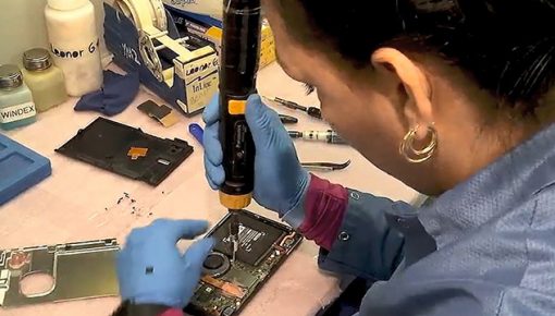 Employee performs soldering on consumer electronics